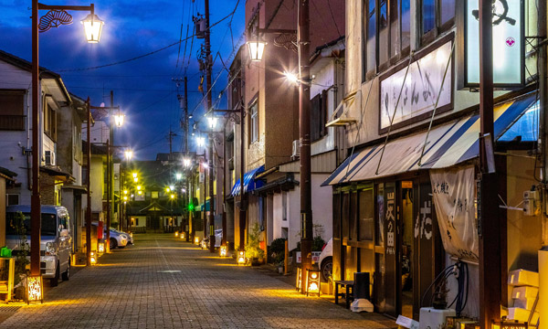 beautiful townscape with stone paving illuminated by lantern lights
